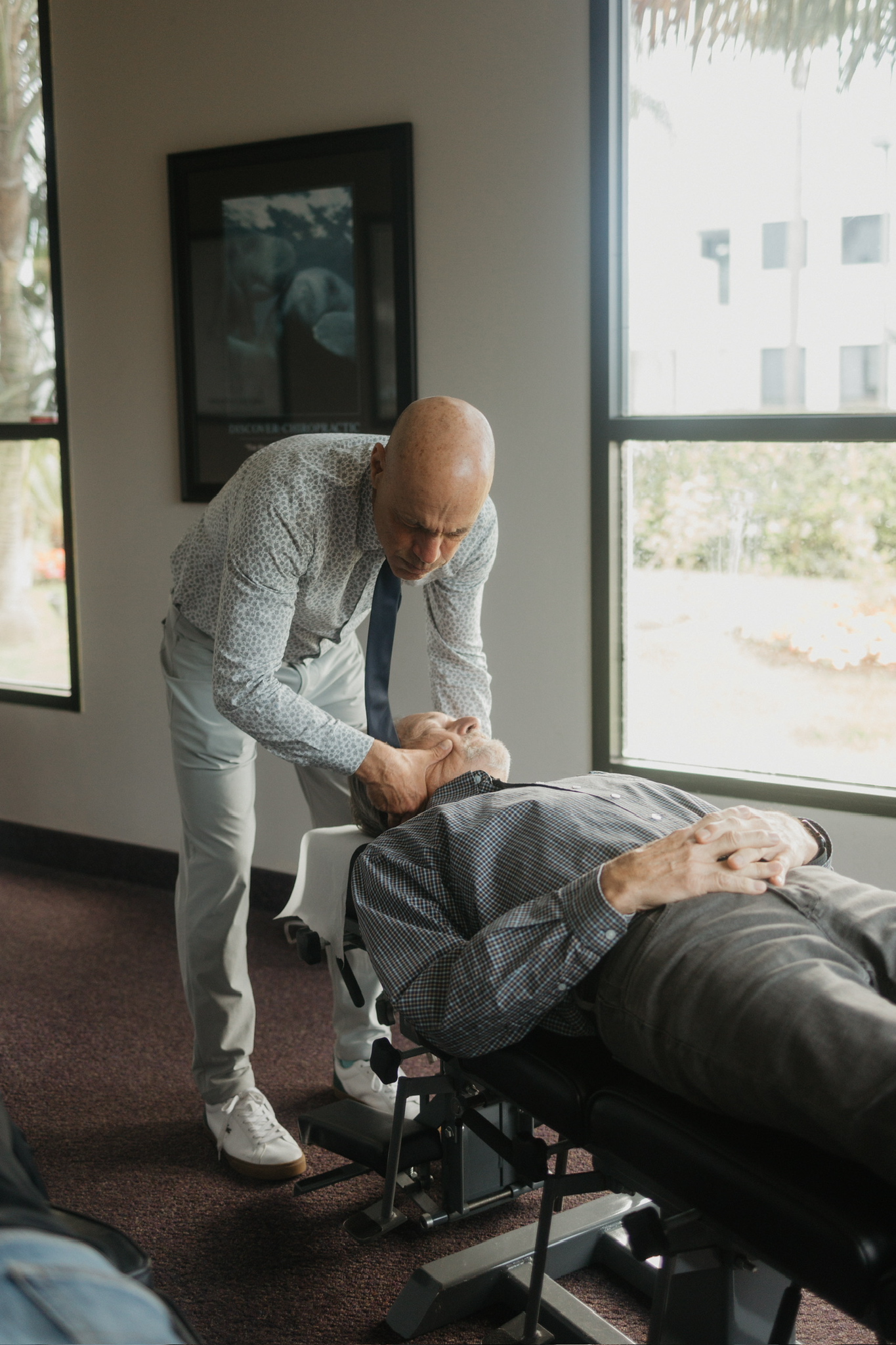A low-force adjustment for an older patient at DeMoss Chiropractic, Newport Beach