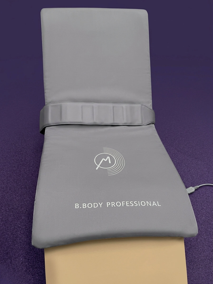The grey BEMER B.Body Professional full-body PEMF applicator mat laid out on a treatment table at DeMoss Chiropractic