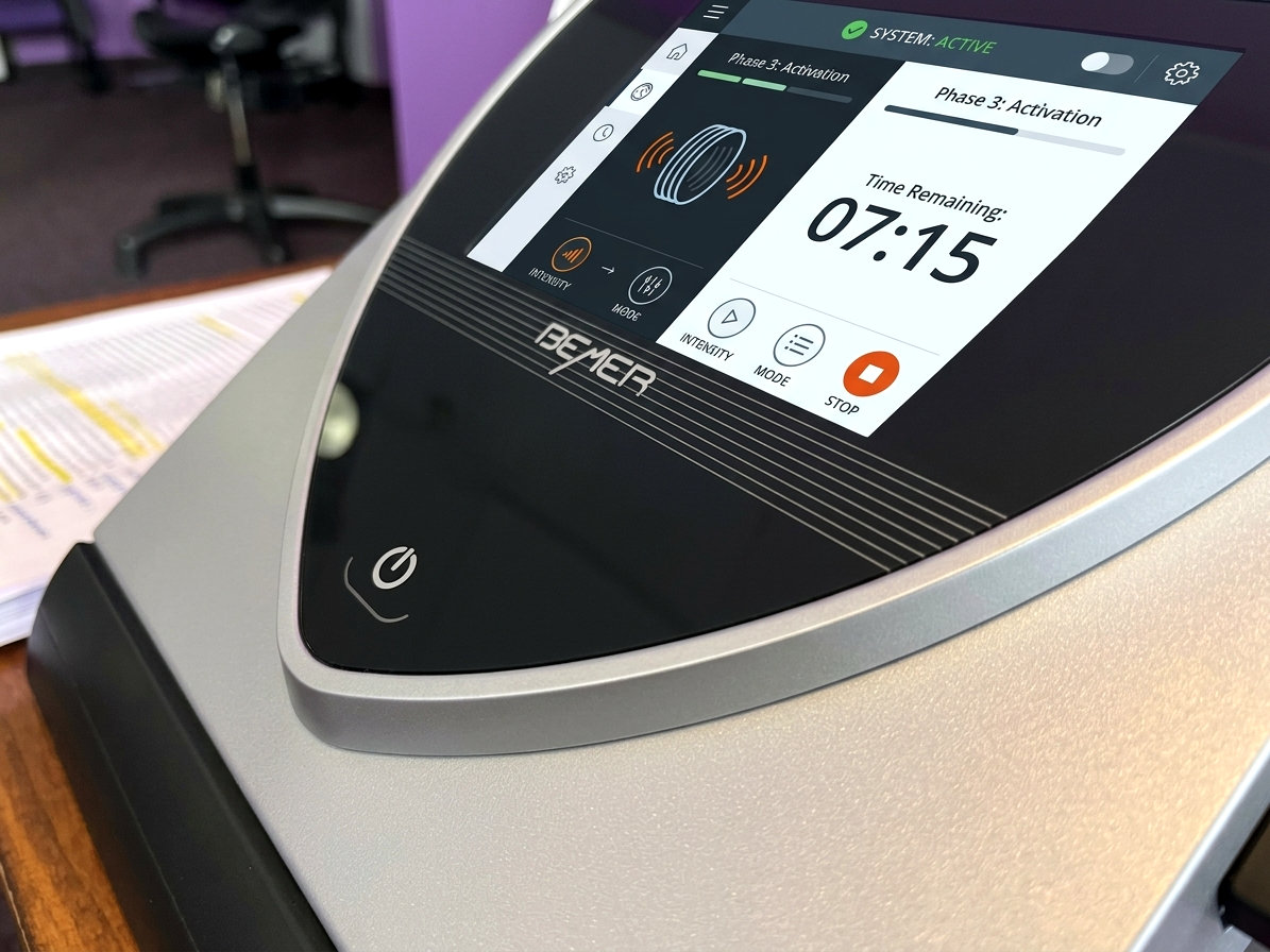 BEMER B.Body Professional control unit at DeMoss Chiropractic, its touchscreen showing Phase 3 Activation with 7 minutes 15 seconds remaining in the session