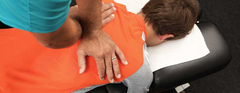 patient receiving drop table chiropractic in Newport Beach CA